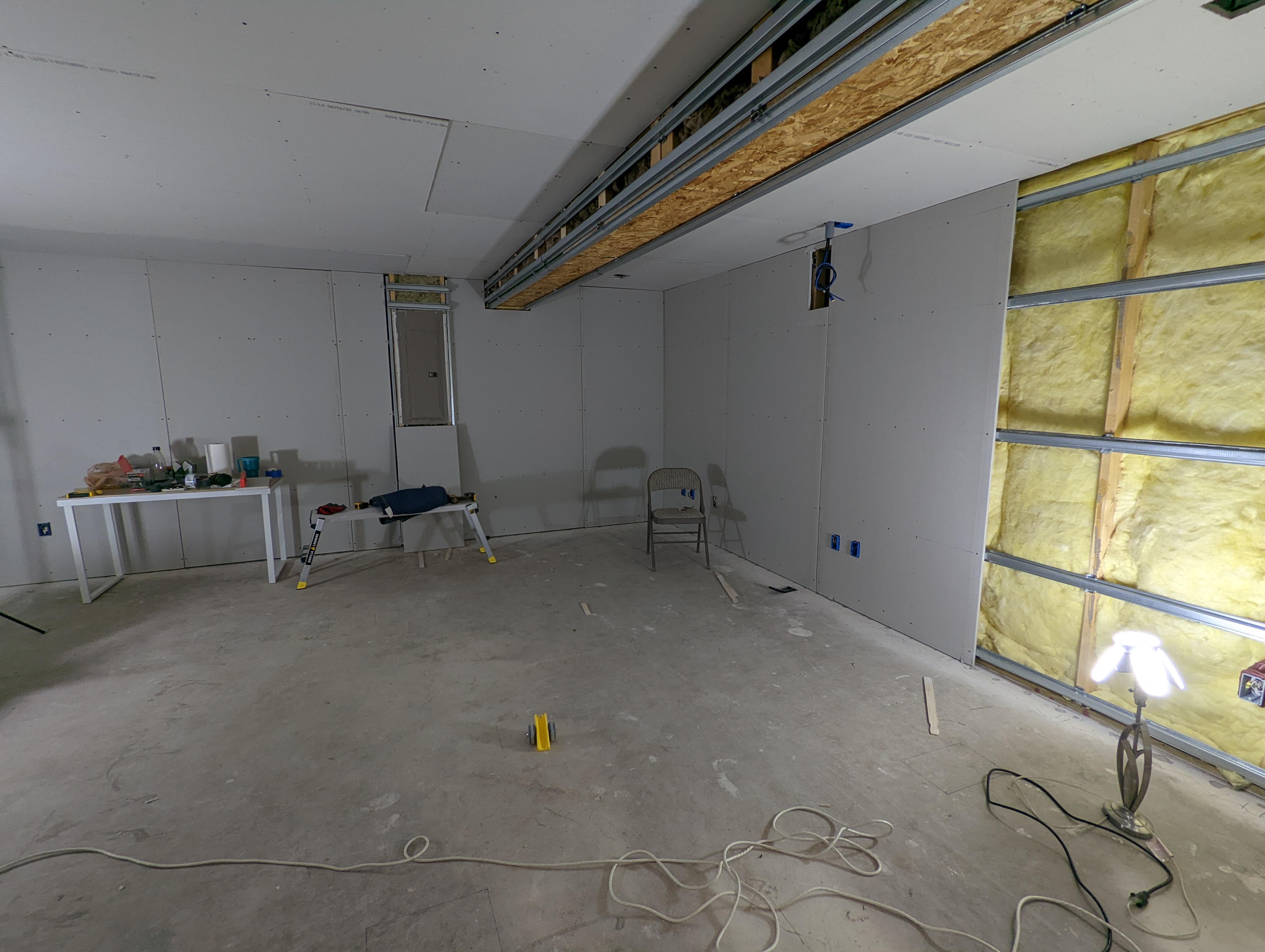 Drywall installation in progress - freshly installed drywall sheets